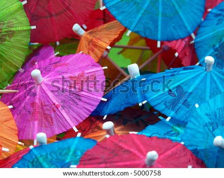 Full frame photo of lots of colorful little drink umbrellas.  Colors include: pink, red, green, orange, and blue.
