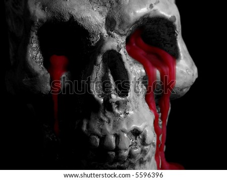 Black and white photo of a wax skull with melted red wax oozing from the eye sockets.