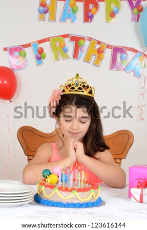 Little girl making birthday wish