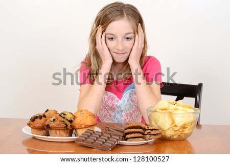 Child with huge pile of junk food