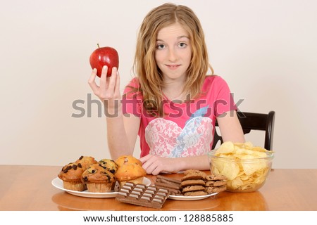 child with apple and junk food concept