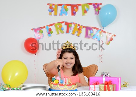 happy child cutting birthday cake