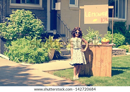 retro girl wearing sunglasses with lemonade stand