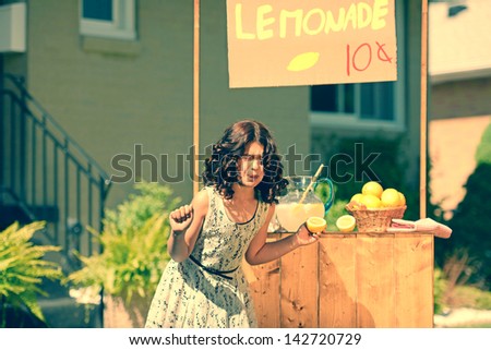 retro girl making funny face holding a lemon