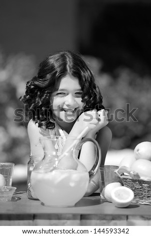 closeup little girl at vintage lemonade stand in black and white