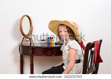 little girl playing dress up