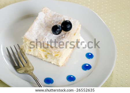 custard cake square on a plate with fork