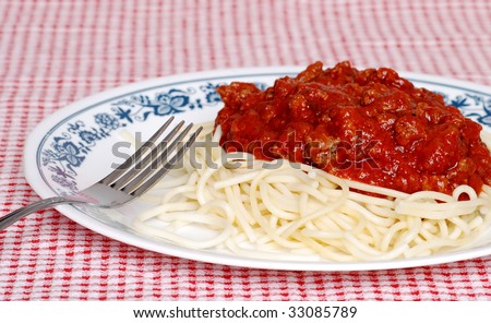 long noodle spaghetti with meat sauce and a fork