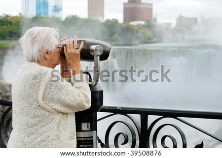 elderly woman looking at american falls in niagara