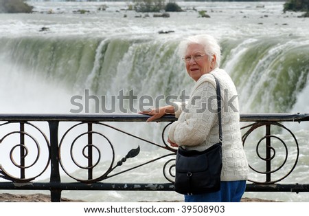 senior woman standing at niagara falls