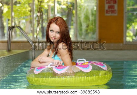 brunette woman in a water floating tube