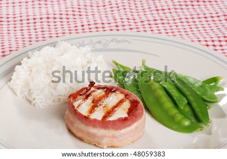 bacon wrapped chicken with snow peas and white rice