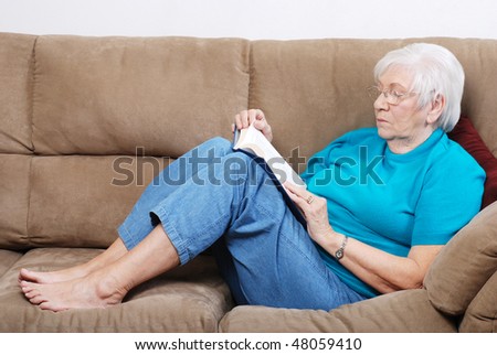senior woman falling a sleep while reading book
