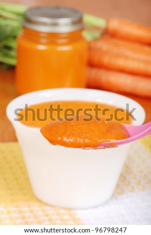 Macro carrot baby food on spoon