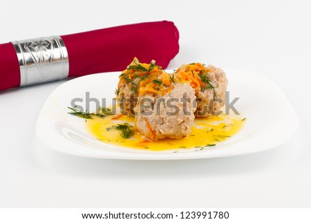 Red cloth napkin and a plate of meat balls and tomatoes