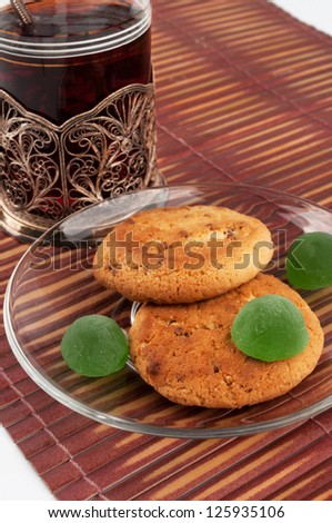 Two round biscuits with green jelly sweets