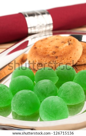 Green jelly candy on shiny metal tray