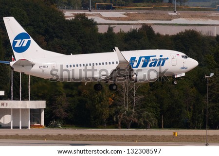 SOCHI, RUSSIA - SEPTEMBER 08: Aircraft operated by UTair, crosses the runway in airport Sochi on September 08, 2012. The company UTair in its fleet has 9 aircraft Boeing-737-800