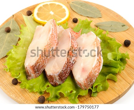 Several pieces of sea bass on a cutting board.