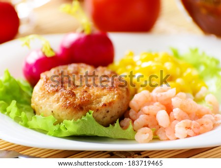 Chicken cutlets with canned corn and peeled shrimp. Served with fresh vegetables.