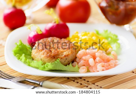 Chicken cutlets with canned corn and peeled shrimp. Served with fresh vegetables.