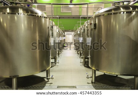 Alley tanks of stainless steel in the shop. The food industry, beer production.