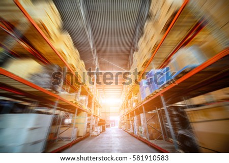Warehouse industrial and logistics companies. Long shelves with a variety of boxes and containers. Motion blur effect. Bright sunlight.