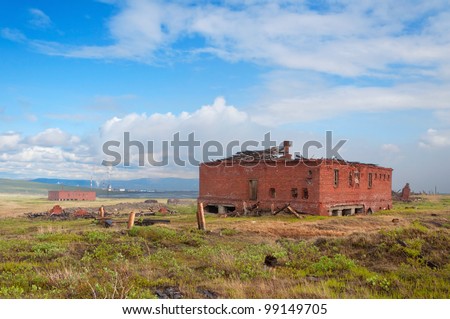The two abandoned brick building in the tundra. Abandoned building on the prison-delivery inactive mine for the extraction of siltstone.
