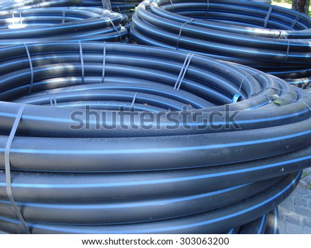 Coiled plastic tubes stored outdoors, before being used