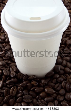 A blank throw-away coffee cup on a coffee bean background.