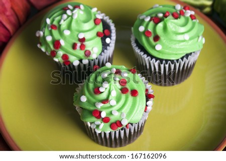 Shot of mini cupcakes on a green plate.