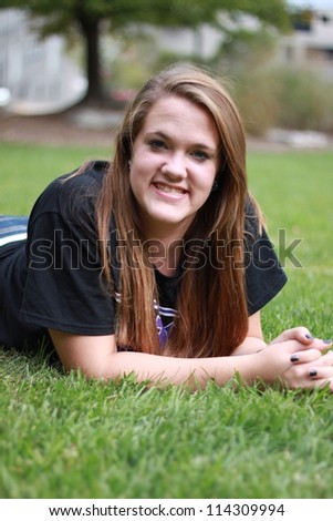Head shot of young woman laying down in a park in Columbia, Missouri