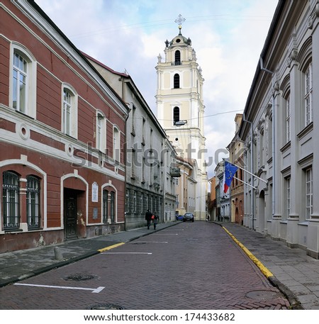 St John street at Vilnius. The bell tower of the church of St. John against the cloudy sky.