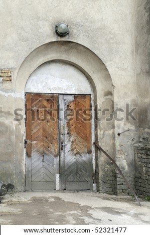 Entrance in old psychiatric hospital, old wooden door