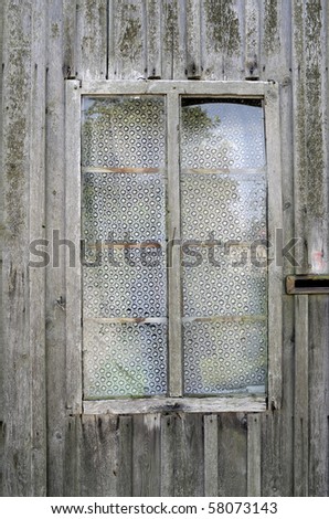 Window with white textured curtains in the old thrown house
