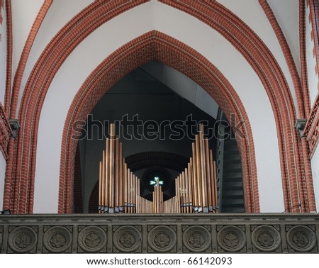Church organ in a small city church. Copper pipes, gothic church