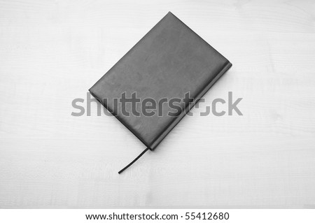 Gray leather diary book laying on wooden table