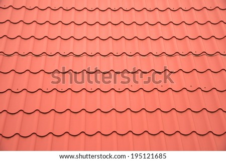 Modern red roof of metal closeup. Red roof as background.