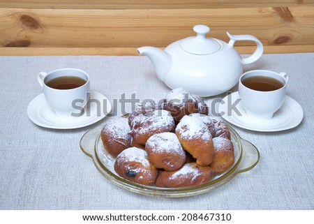Donuts stuffed with currants. Traditional tea.