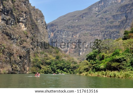 Canyon del Sumidero in Mexico - popular place for Boat Trips. A boat sailing in canyon waters.