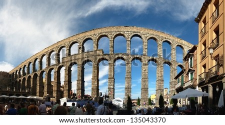 SEGOVIA - JULY 12: People waiting for the concert to start, which is taking place under the old roman aqueduct on July 12, 2012 in Segovia, Spain