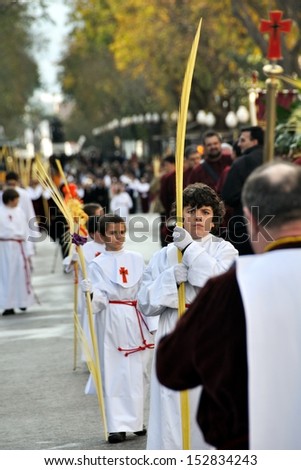 TARRAGONA, SPAIN - MARCH 24: Religious Palm Sunday procession during the Easter at the streets of Tarragona, Spain on March 24, 2013. Young people carry palm wovens