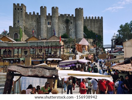 OBIDOS, PORTUGAL - JULY 27: Crowded \'Medieval Market\' in Obidos, Portugal on July 27, 2013. For two week the town hosts the market around the Castle.