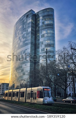 DUSSELDORF, GERMANY - MARCH 19, 2014: Modern architecture in the city center with tram at sunset. In 1896, the first electric tram ran in city, nowadays its eleven tram lines ran over 78.0 km of route