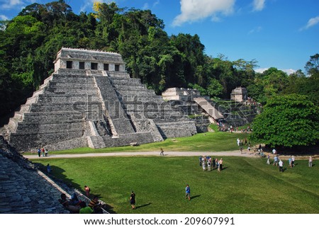 PALENQUE, MEXICO - MARCH 20, 2011: People at mayan ruins with Palace and observatory. It is one of the best preserved sites, which contains interesting architecture and is popular tourist attraction