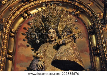 BARCELONA, SPAIN - APRIL 6, 2013: Religious sculpture of Mother Mary wearing a golden crown with a child made inside one of the churches in the city