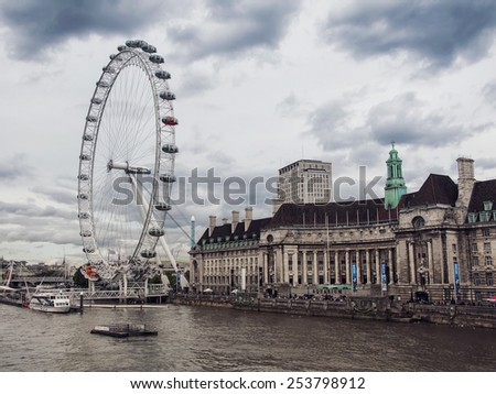 LONDON - AUGUST 30, 2014: Tourists riding the London Eye. It\'s a famous tourist attraction over river Thames, providing great views of London.