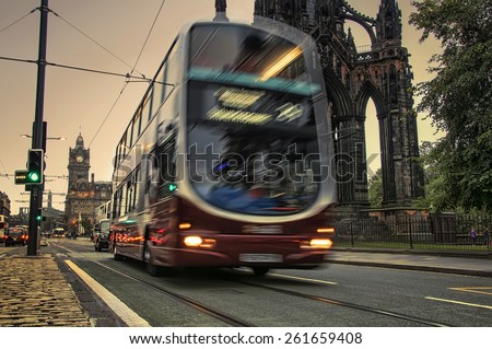 EDINBURGH, SCOTLAND - SEPTEMBER 17, 2014: Blurry two-deck Lothian Volvo bus in the city center in the evening. The company is the largest provider of services in the city.
