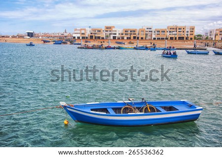Boat with bicycle inside in Rabat, Morocco with new houses at the background