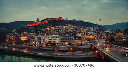 Aerial evening view of Old Tbilisi, Georgia with illuminated castle at the background